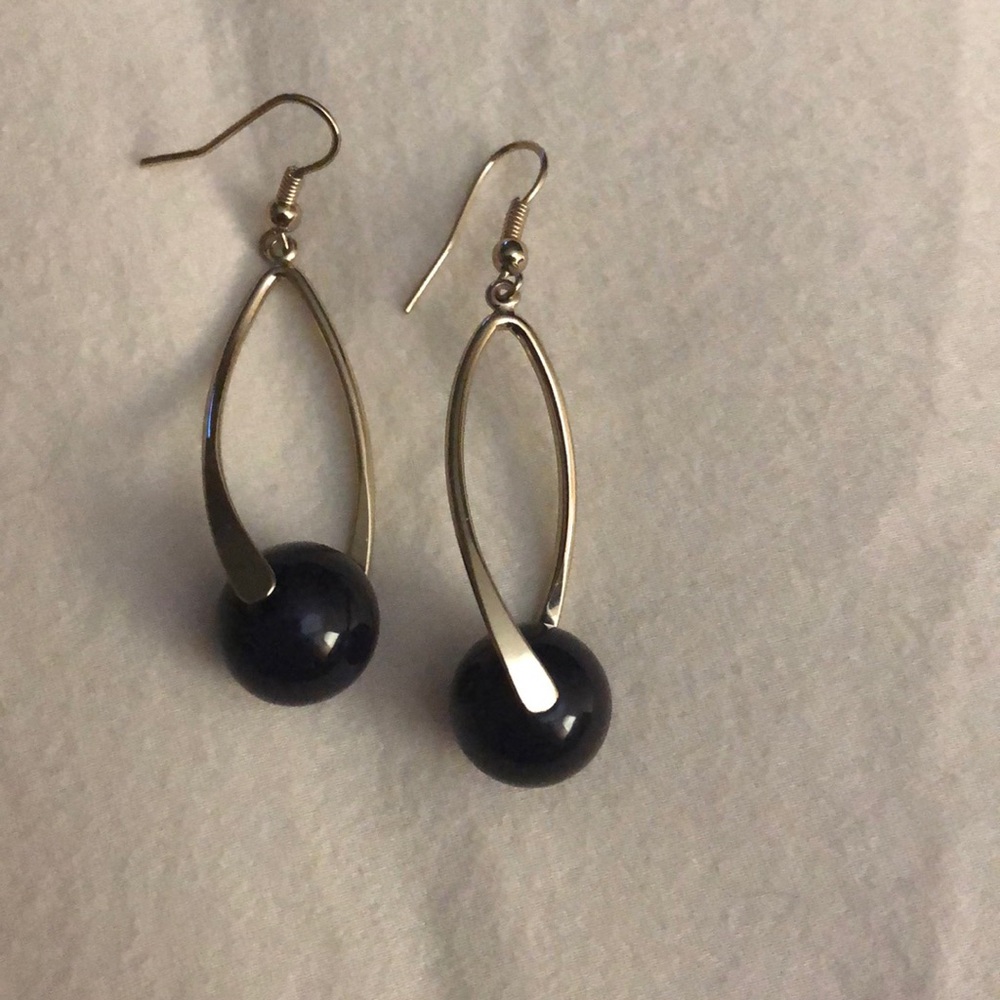 Silver tone earrings with a blue ball at bottom